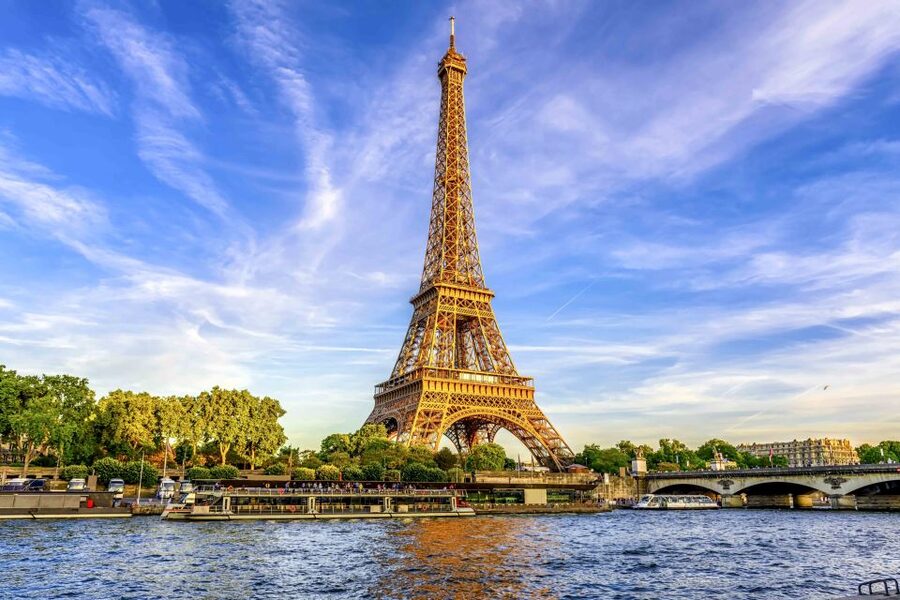 Paris: Eiffel Tower Access by Elevator & Seine River Cruise - Walking toward the Eiffel Tower with an English-speaking guide
